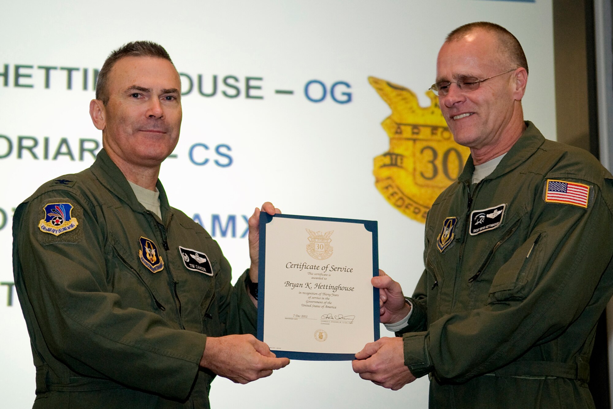 GRISSOM AIR RESERVE BASE, Ind. -- Col. William T. "Tim" Cahoon, 434th Air Refueling Wing commander, presents Senior Master Sgt. Bryan Hettinghouse with a certificate and pin recognizing him for 30 years of federal civil service at a recent civilian commander's call here. Hettinghouse is a standardization and evaluation boom operator with the 434th Operations Group. (U.S. Air Force photo/Tech. Sgt. Mark R. W. Orders-Woempner)
