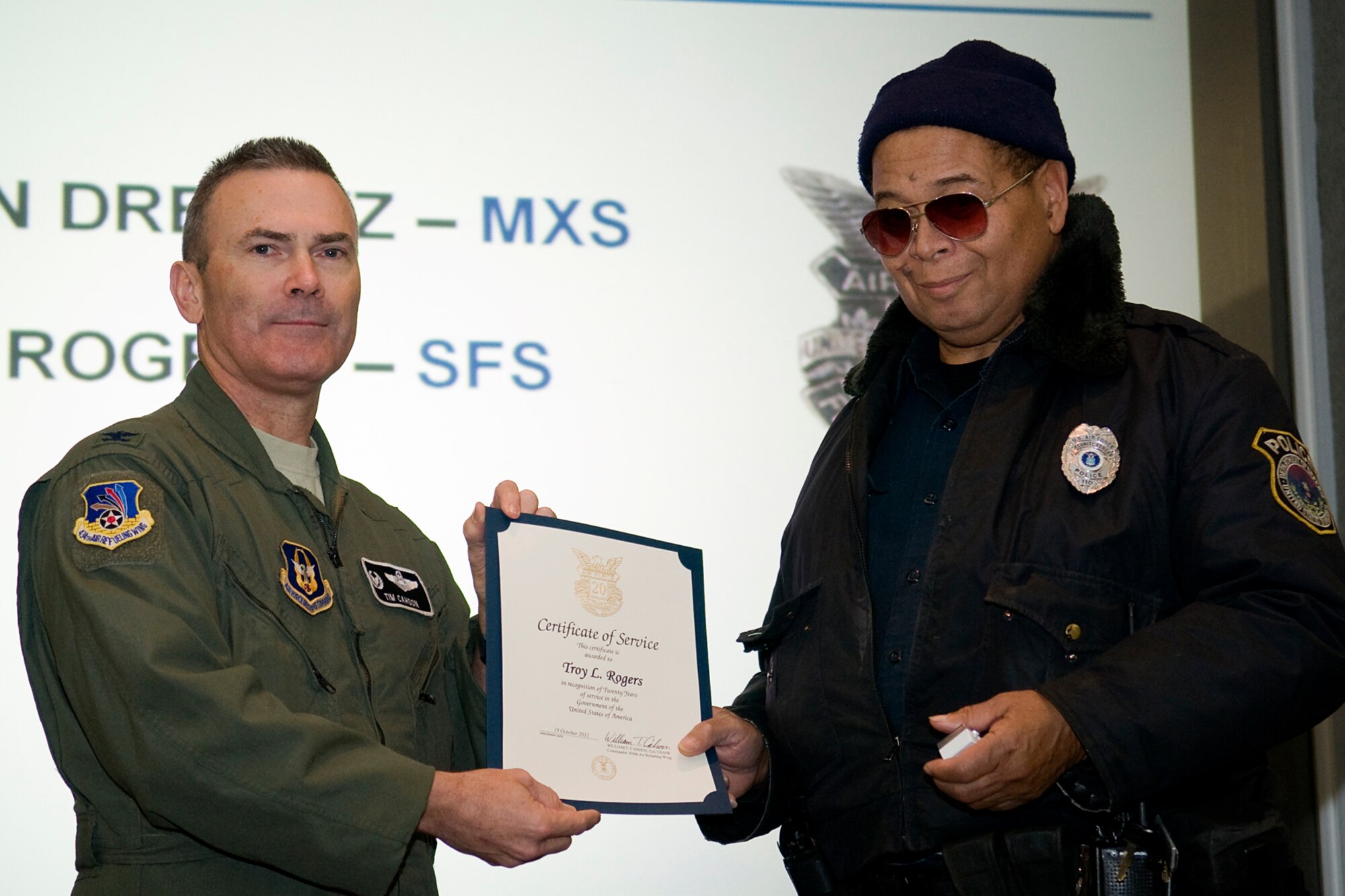GRISSOM AIR RESERVE BASE, Ind. -- Officer Troy Rogers, 434th Security Forces Squadron, receives his certificate of recognition for 20 years of civil service from Col. William T. "Tim" Cahoon, 434th Air Refueling Wing commander, during a civilian commander's call held here Dec 8. Rogers, along with five other civilian employees were recognized for their civil service accomplishments. (U.S. Air Force photo/Tech. Sgt. Mark R. W. Orders-Woempner)
