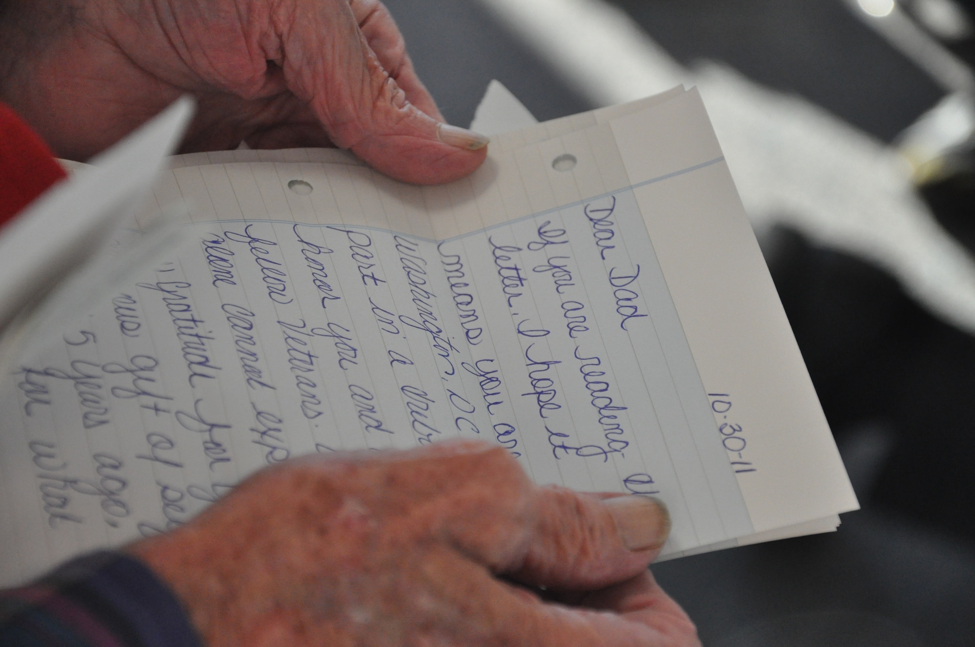 Ed Barnett, who served in the Navy and Army Air Corps in World War II and later in the Air Force, reads a letter from a family member during an Honor Flight to Washington, D.C. Honor Flights take veterans of WW II to the memorial built to honor their sacrifice. (U.S. Air Force photo/2nd Lt. Cait Suttie) 
