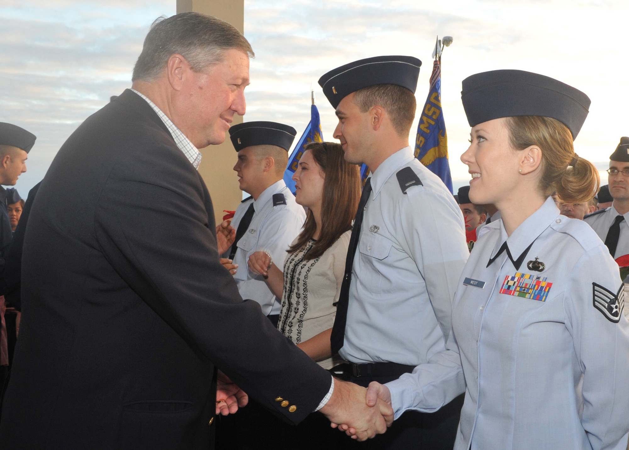 Secretary of the Air Force Michael Donley shakes hands with Staff Sgt. Bethany West, 65th Contracting Flight, during a Warrior Welcome and Departure ceremony at Lajes Field, Azores, Dec. 19, 2011. The Secretary attended the ceremony for Lajes Airmen who have returned from deployments or who are about to deploy.  (U.S. Air Force photo/Guido Melo)