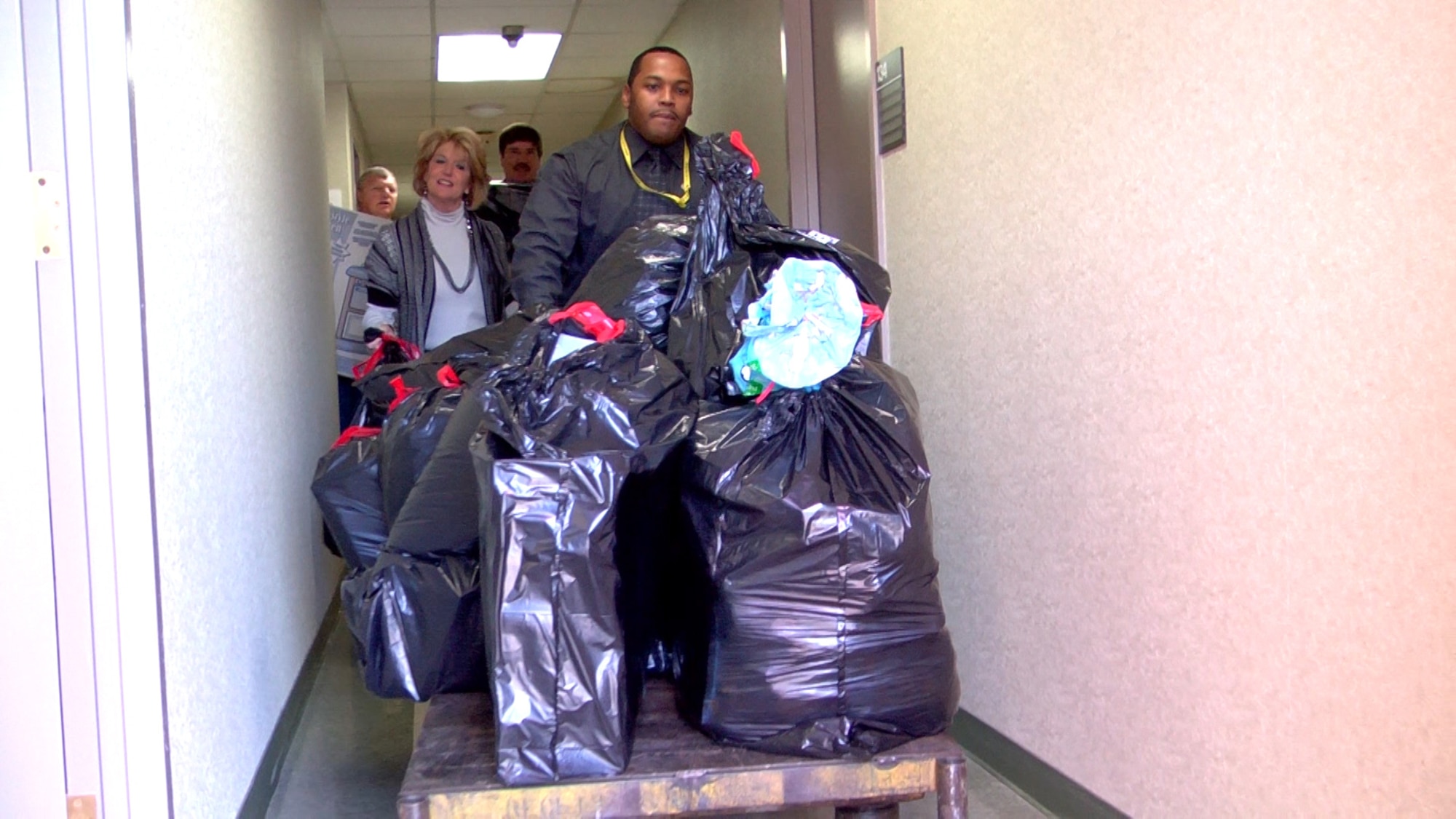 Art Walker, an AEDC Investments project manager, pushes a load of gifts being picked up for Angel Tree children Dec. 13. Walker volunteered to help with the AEDC program this Christmas because he was an Angel Tree recipient as a child. (Photo by Patrick Ary)