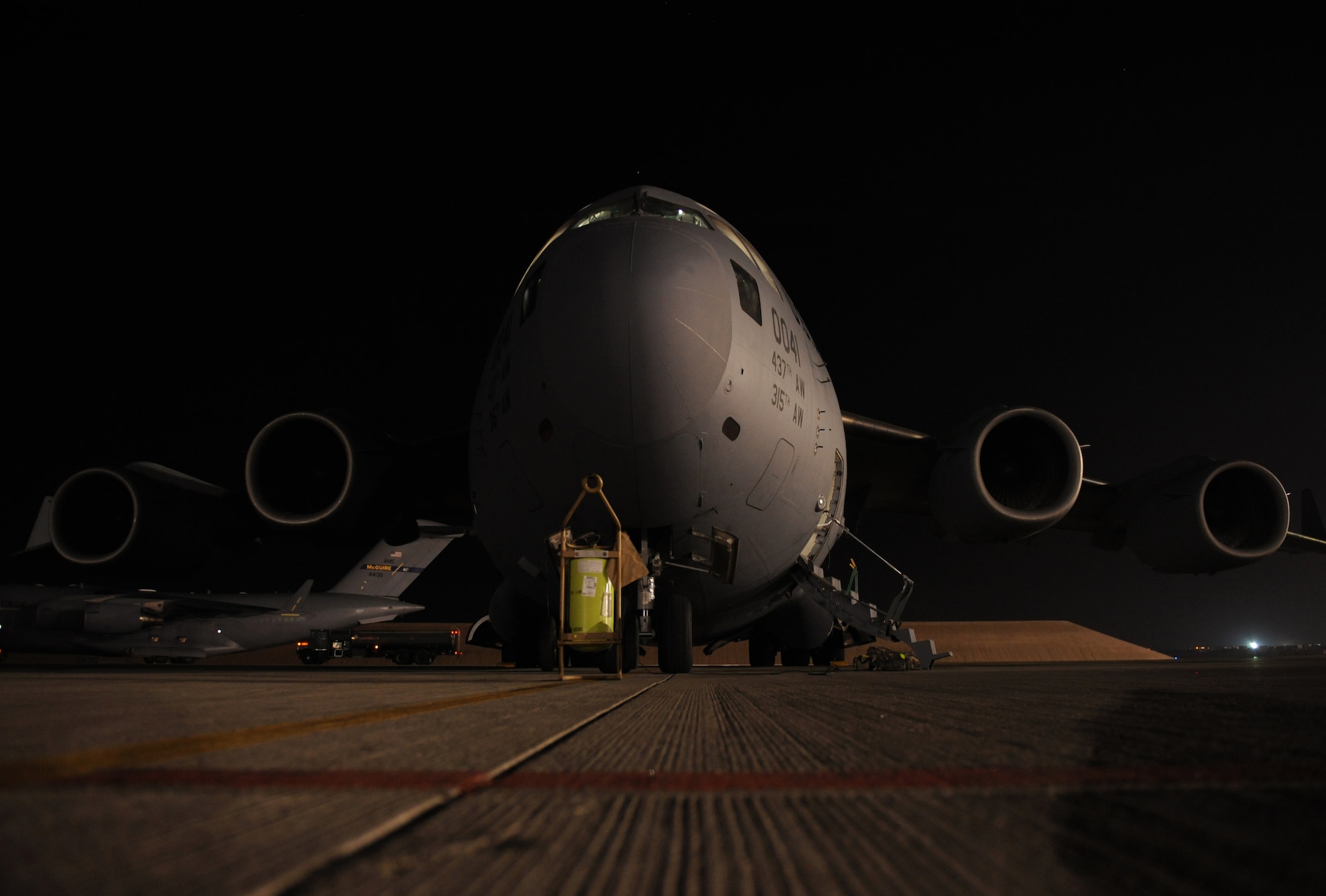 SOUTHWEST ASIA – A C-17 Globemaster III from the 816th Expeditionary Airlift Squadron sits on the tarmac prior to a mission here Dec. 23, 2011. The 816th EAS transported nearly three million pounds of cargo to forward operating locations throughout Southwest Asia last month, and routinely works with the 8th Expeditionary Air Mobility Squadron and the U.S. Army 421st Quartermaster Company Parachute Riggers to prep for air supply missions over Afghanistan. (U.S. Air Force photo/Staff Sgt. Nathanael Callon)