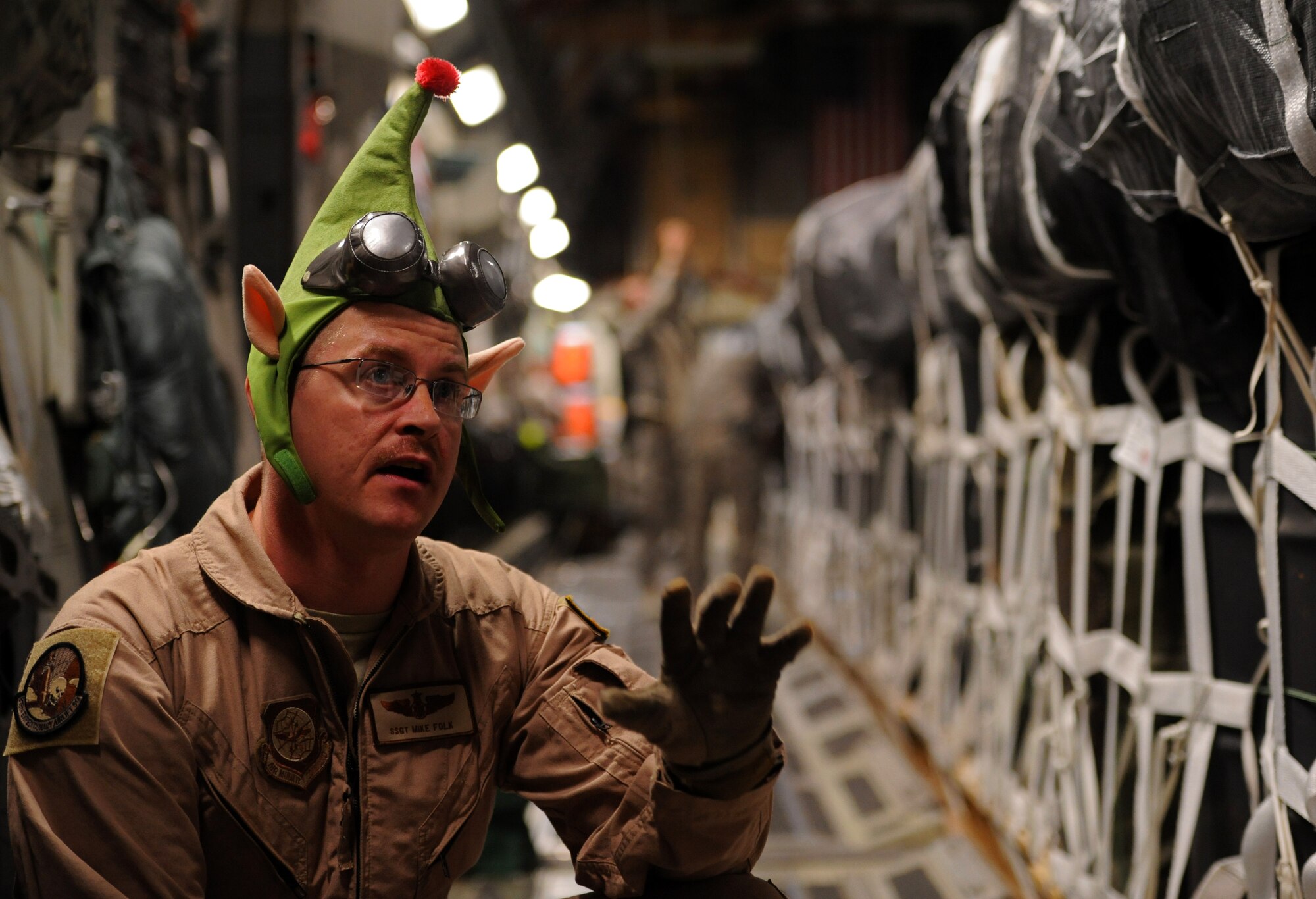 SOUTHWEST ASIA – Staff Sgt. Mike Folk, 816th Expeditionary Airlift Squadron loadmaster, directs Airmen from the 8th Expeditionary Air Mobility Squadron while loading pallets of fuel onto a C-17 Globemaster III prior to a mission here Dec. 23, 2011. The 816th EAS works with the 8th EAMS and the U.S. Army 421st Quartermaster Company Parachute Riggers to prep for air supply missions over Afghanistan. Folk is deployed from Charleston Air Force Base, S.C. (U.S. Air Force photo/Staff Sgt. Nathanael Callon)