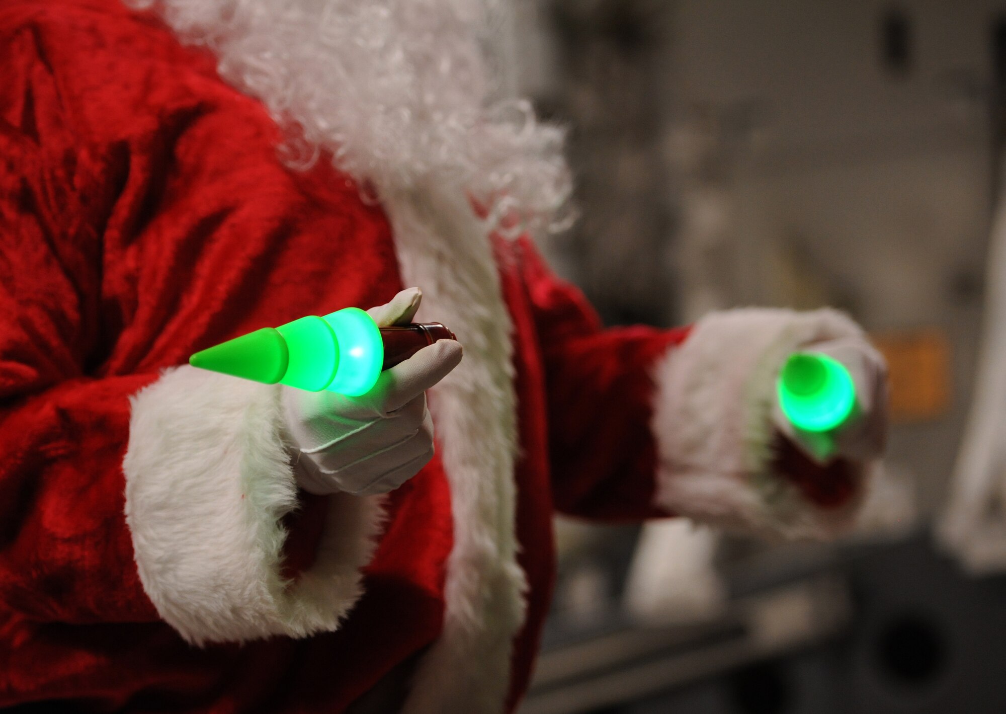 SOUTHWEST ASIA – Santa Claus, portrayed by Tech. Sgt. Mike Morris, 816th Expeditionary Airlift Squadron Loadmaster Flight NCO in charge and native of Charleston, S.C., directs a 60K loader to the ramp of a C-17 Globemaster III using Christmas tree light sticks prior to a mission here Dec. 23, 2011. The 816th EAS airdropped 40 pallets of fuel to remote forward operating bases in Afghanistan. The fuel will be used for generators, heaters and vehicles. Morris is deployed from Charleston Air Force Base, S.C.  (U.S. Air Force photo/Staff Sgt. Nathanael Callon)