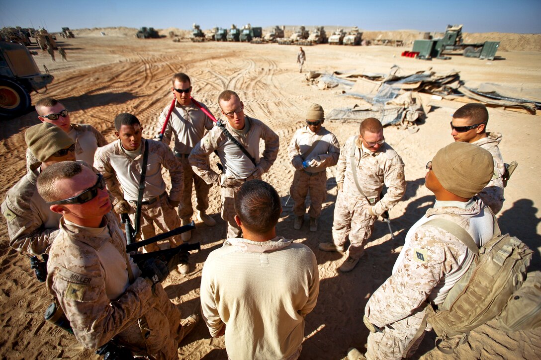 U.S. Marine Corps Cpl. James Hernandez offers a word of encouragement and motivation to the Marines under his charge on Firebase Saenz in Afghanistan's Helmand province, Dec. 14, 2011. Flores is a combat engineer assigned to Alpha Company, 9th Engineer Support Battalion. The firebase is the first of several patrol bases being demilitarized by the Marines in December.
