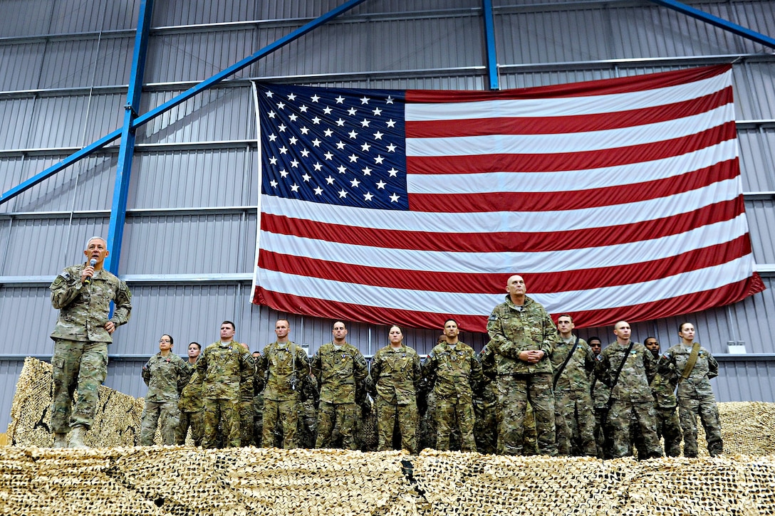 U.S. Army Maj. Gen. James L. Huggins, left, introduces U.S. Army Chief of Staff Gen. Raymond T. Odierno to a crowd of servicemembers during an award and re-enlistment ceremony on Kandahar Airfield, Afghanistan, Dec. 21, 2011. Huggins is the commanding General, 82nd Airborne Division and International Security Assistance Force, Regional Command South.