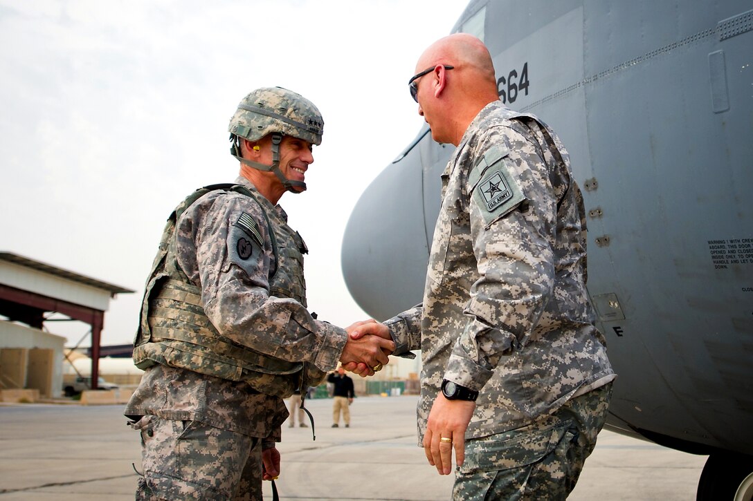 U.S. Army Lt. Gen. Robert L. Caslen Jr., left, greets U.S. Army Chief of Staff Gen. Raymond T. Odierno, upon his arrival at Baghdad International Airport in Baghdad, Dec. 22, 2011. Caslen is the commanding general of the Office of Security Cooperation-Iraq.
