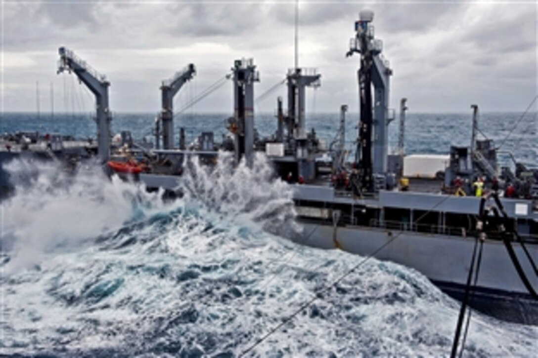 Heavy waves crash against the USNS Tippecanoe during a replenishment-at-sea mission with the USS Makin Island under way in the Pacific Ocean, Dec. 20, 2011. U.S. sailors and Marines assigned to the USS Abraham Lincoln, the USS Carl Vinson and the USS Makin Island performed several operations between Dec. 13 and Dec. 20, 2011, while under way in the Pacific Ocean. 
