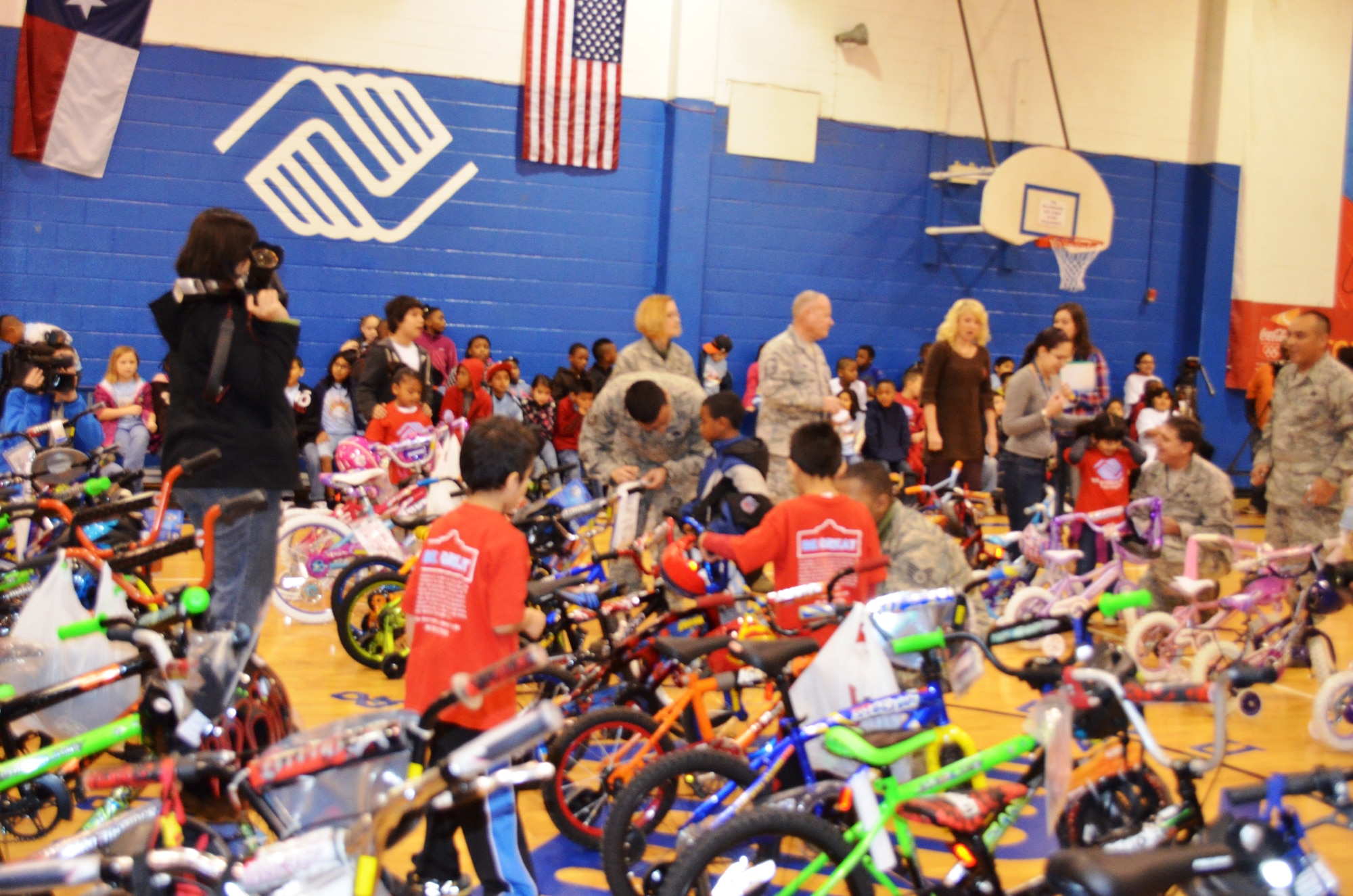 San Antonio Boys & Girls Club youths, with assistance from 433rd Airlift Wing members, search for a new bike to own. For the third consecutive year, the Alamo Wing Top Three gathered bikes and safety equipment to donate to children in need. Youth were selected on the basis of participation, behavior, and grades by Boys & Girls Club staff members from branches throughtout San Antonio, Texas. (U.S. Air Force photo/ Tech Sgt. Carlos J. Trevino)  