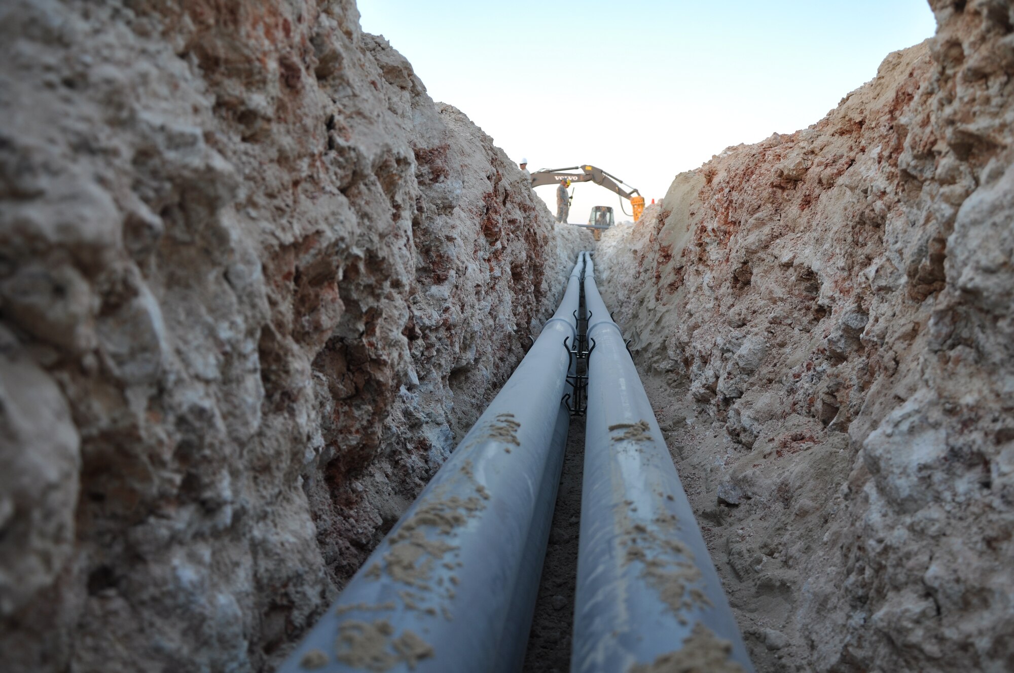 Airmen from the A67 Engineer and Installation Team work to replace an above-ground tactical fiber run, which is a cable that provides connectivity from one section of the base to another, Dec. 19, 2011. The team worked for four days to replace the communications line with a permanent and more secure underground conduit. (U.S. Air Force photo/ Senior Airman Michael Charles)