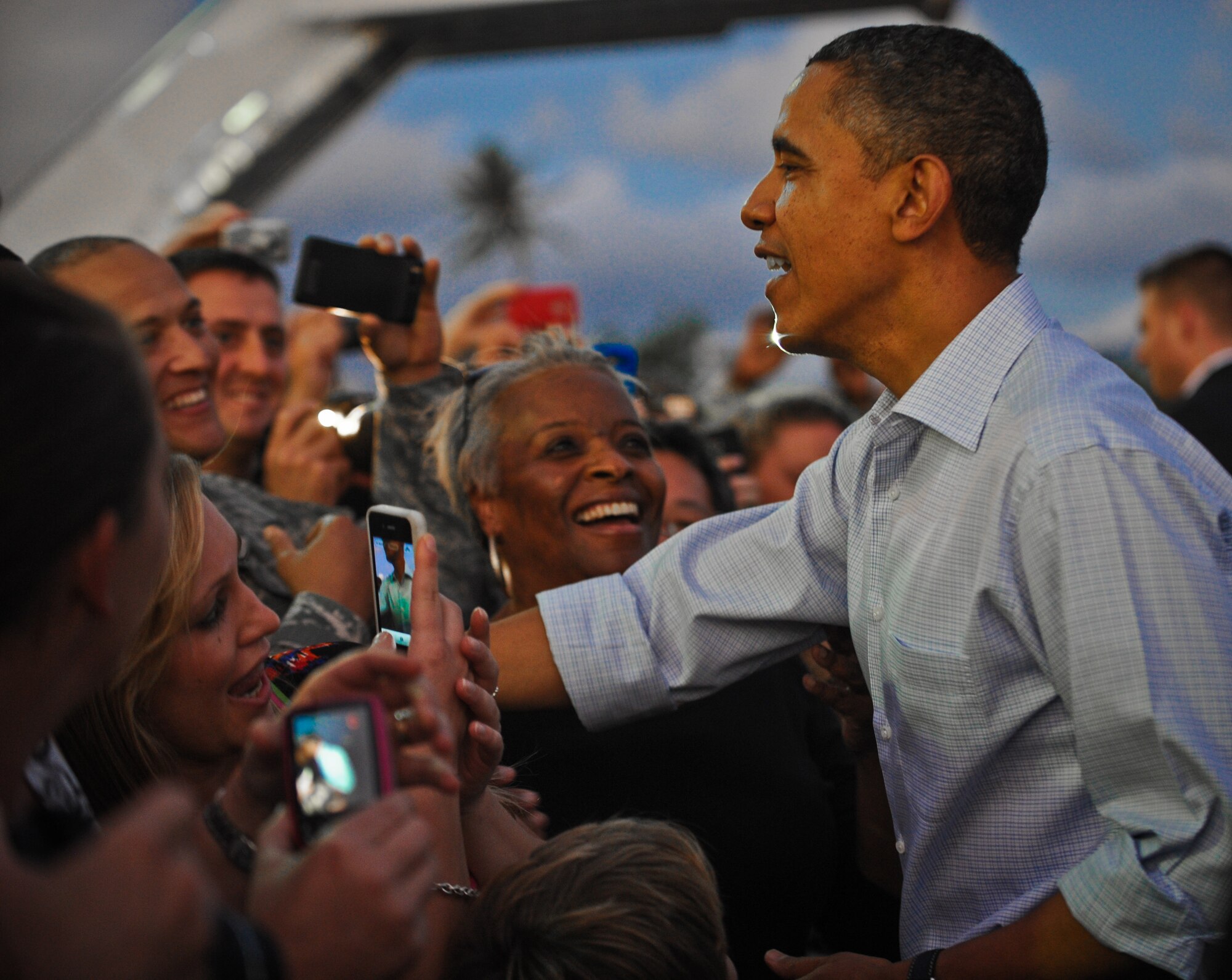 President Barack Obama shakes hands with Col. Sam Barrett, 15th Wing commander,  upon his arrival to Joint Base Pearl Harbor-Hickam, Hawaii, Dec. 23. The president and his family are expected to stay through the New Year holiday and enjoy the warm weather on the island. (U.S. Air Force photo/Senior Airman Lauren Main)