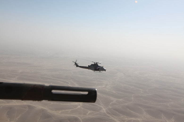 A Marine Corps UH-1Y Huey with Marine Light Attack Helicopter Squadron 369 flies the American flag while soaring above Helmand province, Afghanistan, Dec. 25. The Marine Corps helicopter squadron flew thousands of pounds of care packages to infantry Marines at austere combat outposts in Afghanistan on Christmas Day.::r::::n::::r::::n::::r::::n::