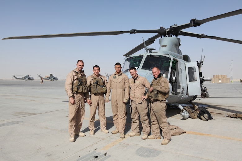 From left, Capt. Joseph Kennedy, Capt. Jeff Barnes, Sgt. Raymond Devor, Staff Sgt. Michael Evans and Lance Cpl. Andrew Harris, stand in front of a UH-1Y Huey from Marine Light Attack Helicopter Squadron 369 at Camp Bastion, Afghanistan, Dec. 25. The Marine Corps helicopter squadron flew thousands of pounds of care packages to infantry Marines at austere combat outposts in Afghanistan on Christmas Day.::r::::n::::r::::n::::r::::n::