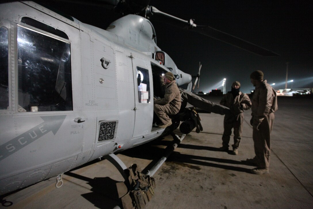 Lance Cpl. Andrew Harris, a crew chief with Marine Light Attack Helicopter Squadron 369, checks care packages loaded onto a Marine Corps UH-1Y Huey at Camp Bastion, Afghanistan, Dec. 25. The Marine Corps helicopter squadron flew thousands of pounds of care packages to infantry Marines at austere combat outposts in Afghanistan on Christmas Day.::r::::n::::r::::n::::r::::n::