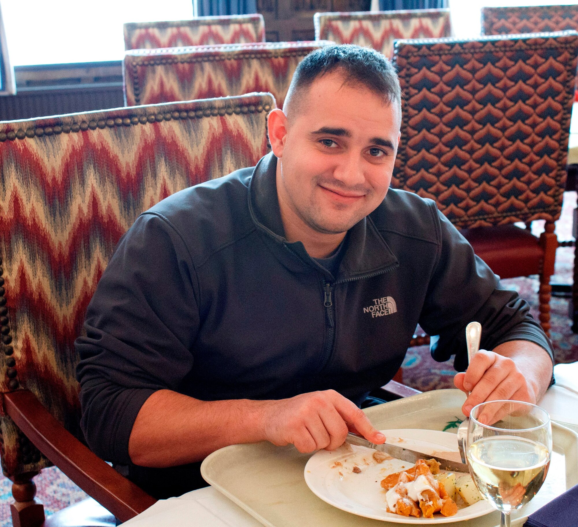 RAF MILDENHALL, England – Senior Airman Samuel Parker, 100th Logistics Readiness Squadron, eats a meal at the RAF Mildenhall Dining Facility here on Christmas Day. Parker said he just got back from a 7-month deployment, and most of his friends have either moved to new bases or are on leave in the United States for the holidays. Parker said he was enjoying the meal and didn’t have any plans for the rest of Christmas day. (U.S. Air Force photo/1st Lt. Jason Smith)