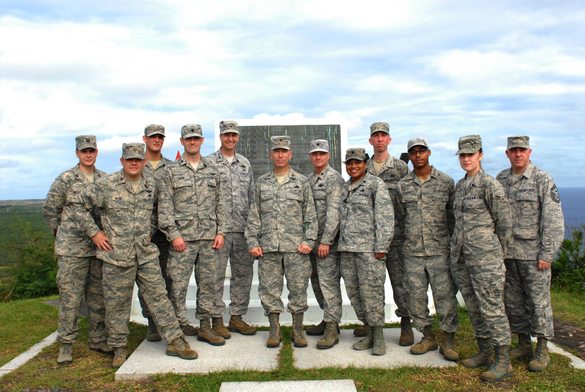 U.S. Air Force 18th Wing members pose for a photo on Mount Suribachi during a trip to Iwo Jima, Dec. 22, 2011. Airmen from the 18th Wing accompanied Marines and Sailors from the 1st Marine Aircraft Wing on a 7.5 mile hike to the top of Mt. Suribachi to pay homage to the fallen heroes of Iwo Jima.  (U.S. Air Force photo by Tech Sgt. Lakisha A. Croley/released)