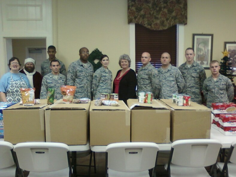 Airmen from the 916th Air Refueling Wing stand with volunteers at the Goldsboro Soup Kitchen just before the Christmas holiday. Airmen from the wing donated more than 800 non-perishable food items. (USAF photo courtesy of SMSgt. Jeff Williams, 916ARW)