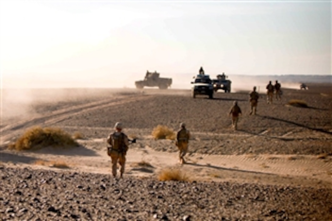 U.S. Marines patrol through the desert while Afghan security forces pass by during Operation Eagle Hunt in Afghanistan. The Marines, assigned to Border Adviser Team 1, worked as a quick-reaction back-up forcefor the Afghan-led operation.