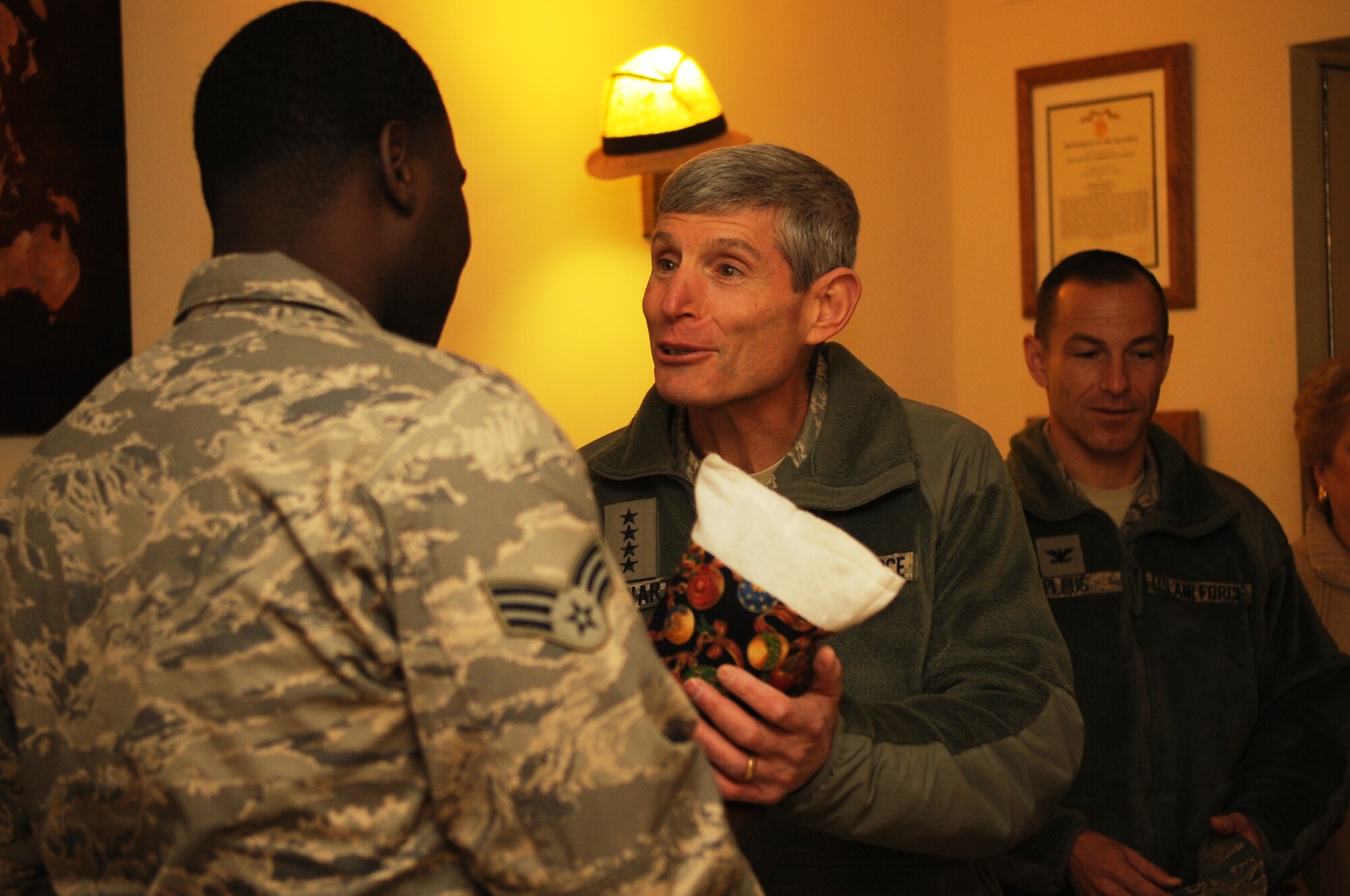 Air Force Chief of Staff Gen. Norton Schwartz presents a holiday stocking to Senior Airman Jeremy Roberts, 8th Logistics Readiness Squadron, Dec. 24, 2011 at Kunsan Air Base, Republic of Korea. The general visited the dorms at Kunsan to see first-hand the quality of life and living conditions for Airmen stationed at Kunsan. (U.S. Air Force photo by Master Sgt. Sonny Cohrs/Released)