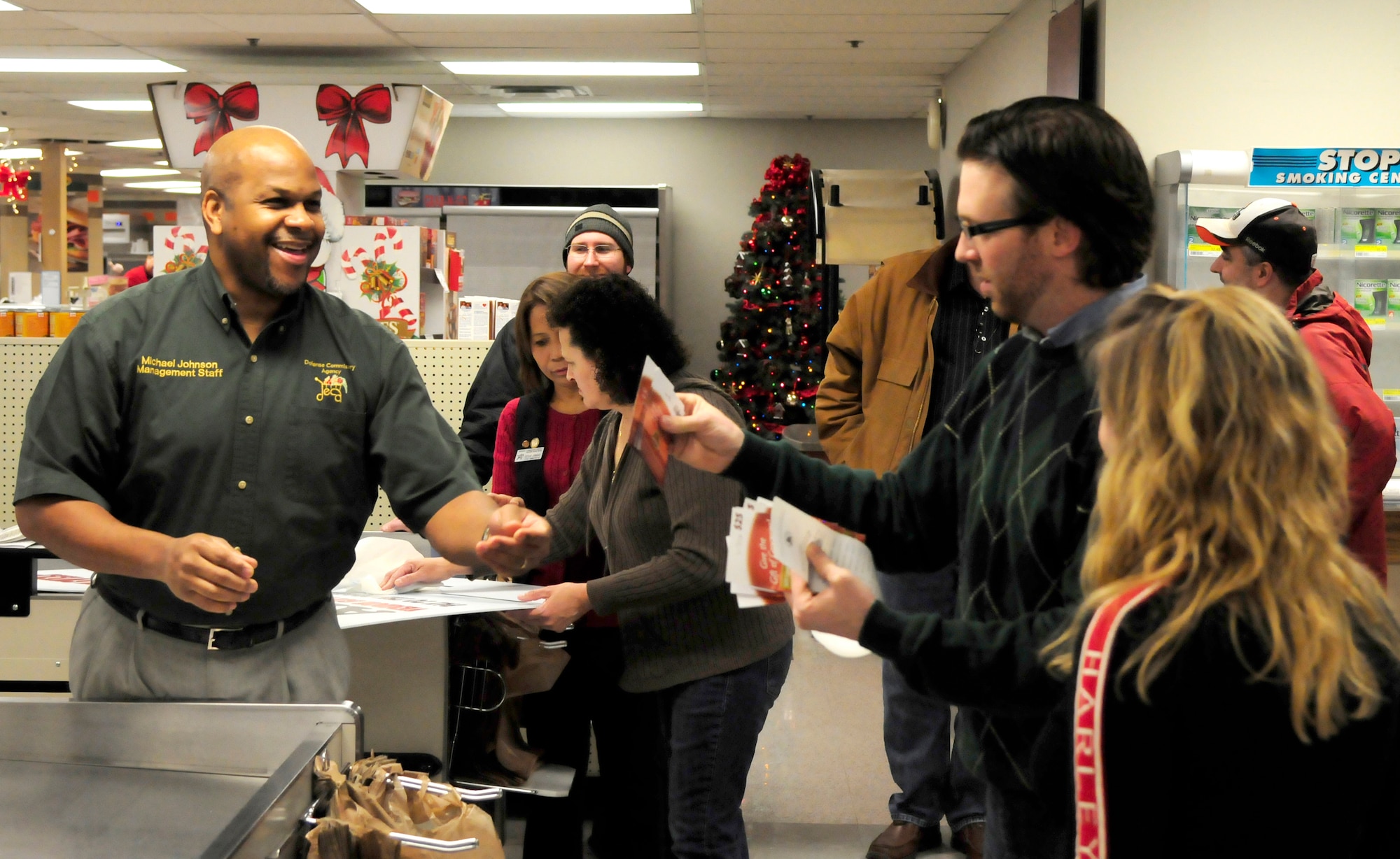 Michael Johnson, Eielson Commissary director, awards $500 in commissary gift cards to Donna Teffeteller, an Air Force retiree from North Pole, Alaska, and Evan Franklin, Science Applications International Corporation contractor, after winning the supermarket sweep contest Dec. 22, 2011, at the base commissary, Eielson Air Force Base, Alaska. The pair spent $1,481.13 in two minutes, winning first place and a $500 shopping spree. (U.S Air Force photo/Tech. Sgt. Tim Jenkins)