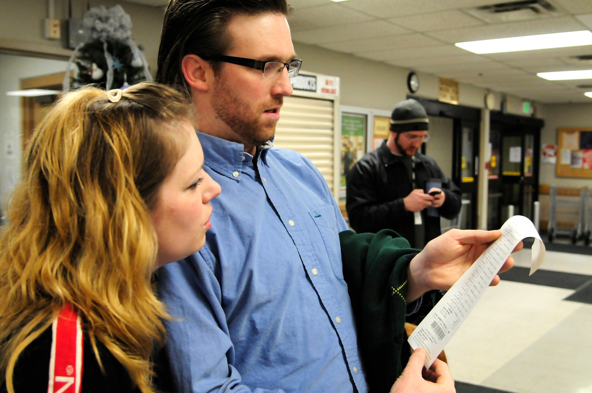 Donna Teffeteller, an Air Force retiree from North Pole, Alaska, and Evan Franklin, Science Applications International Corporation contractor, view their receipt after competing in the supermarket sweep contest Dec. 22, 2011, at the base commissary, Eielson Air Force Base, Alaska. The couple spent $1,481.13 in two minutes, winning them first place and a $500 commissary shopping spree. (U.S Air Force photo/Tech. Sgt. Tim Jenkins)