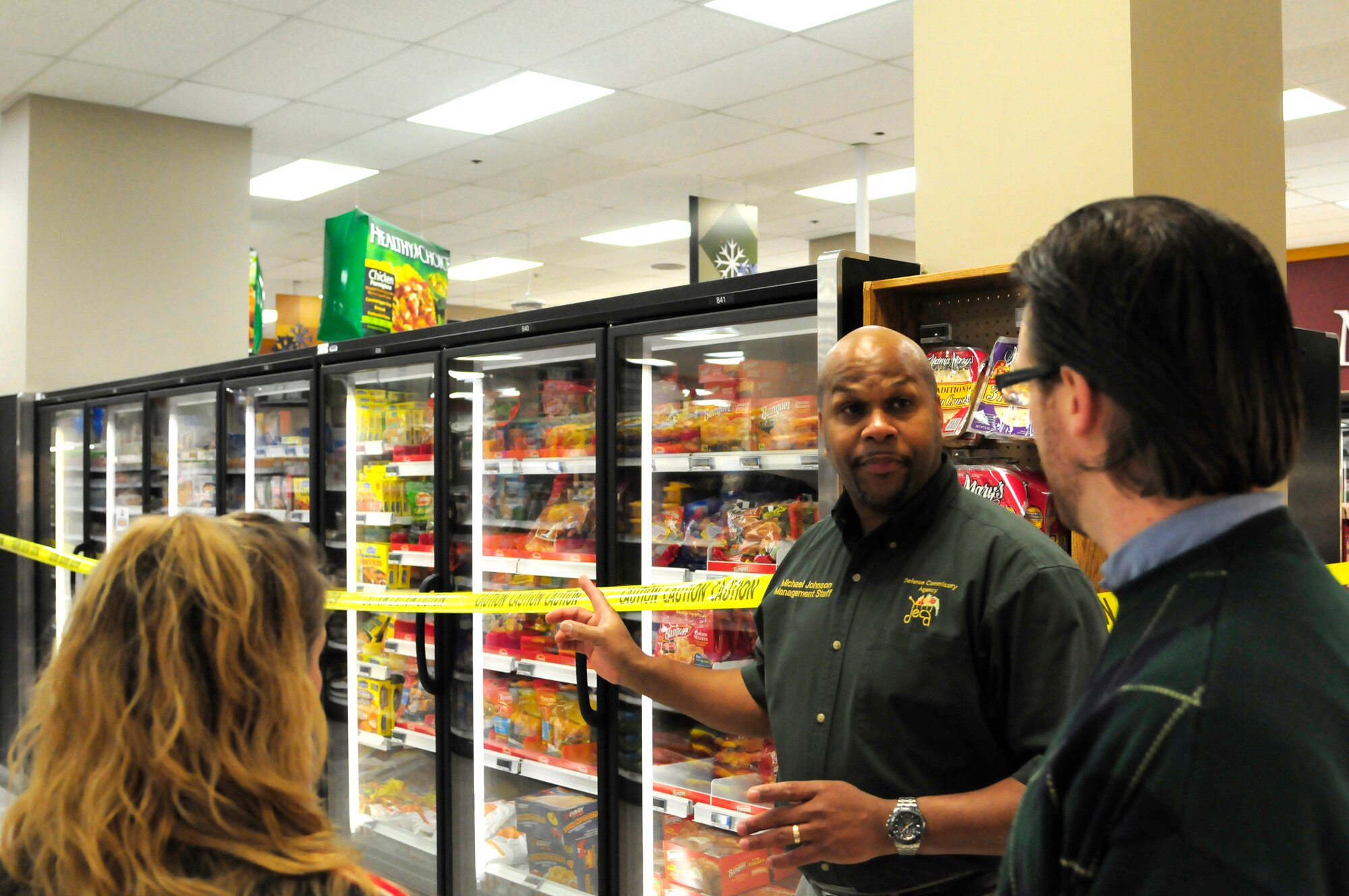 Michael Johnson, Eielson Commissary store director, explains the supermarket sweet contest rules at the base commissary Dec. 22, 2011, Eielson Air Force Base, Alaska. The event allowed three contestants to compete for commissary shopping sprees. (U.S Air Force photo/Tech. Sgt. Tim Jenkins)