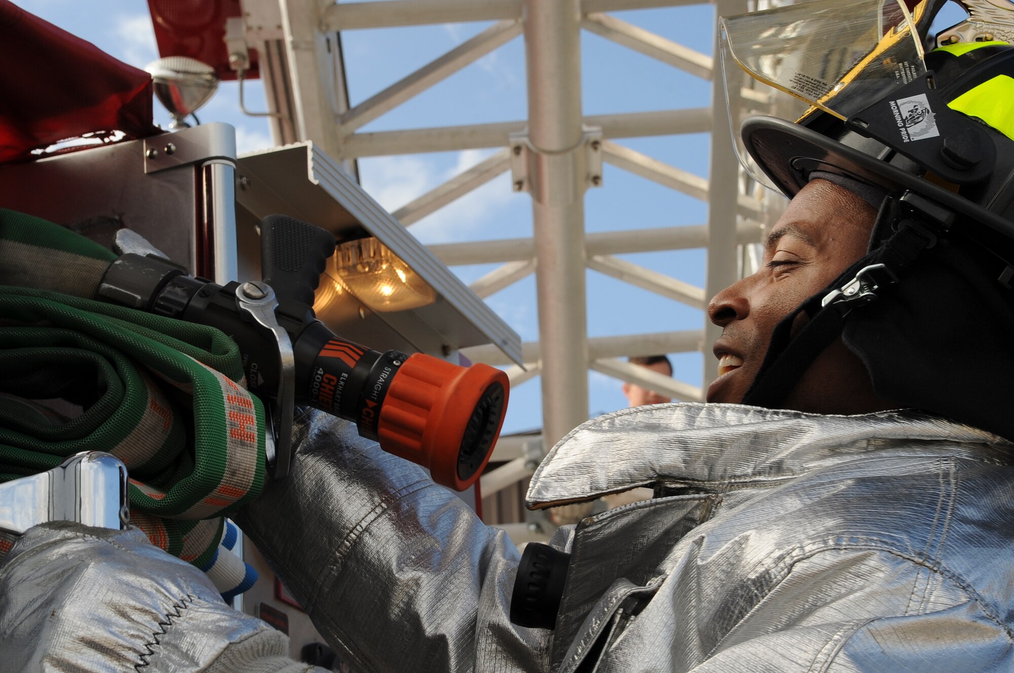 U.S. Air Force Airman 1st Class Dexter Tidwell Jr., 23rd Civil Engineer Squadron firefighter, obtains a hose from ladder number 11 at Moody Air Force Base, Ga., Dec. 20, 2011. Tidwell along with approximately 15 Airmen will be spending the holiday season working. (U.S. Air Force photo by Airman 1st Class Olivia Dominique/Released)