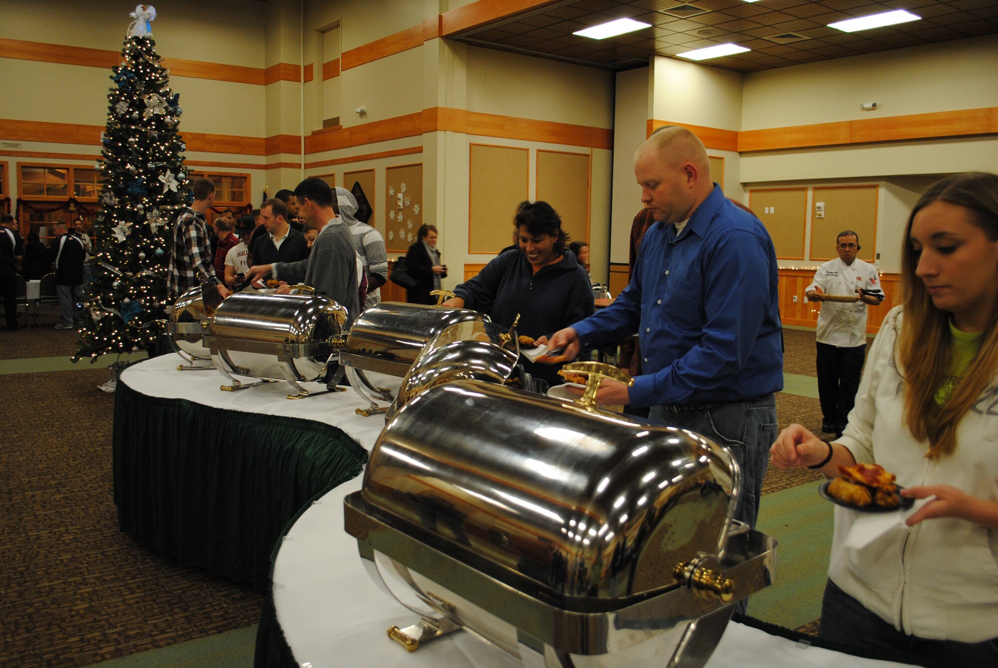 Members line up for an array of finger foods provided at the Operation Holiday Cheer wrap-up party Dec. 15 at the Grizzly Bend. 