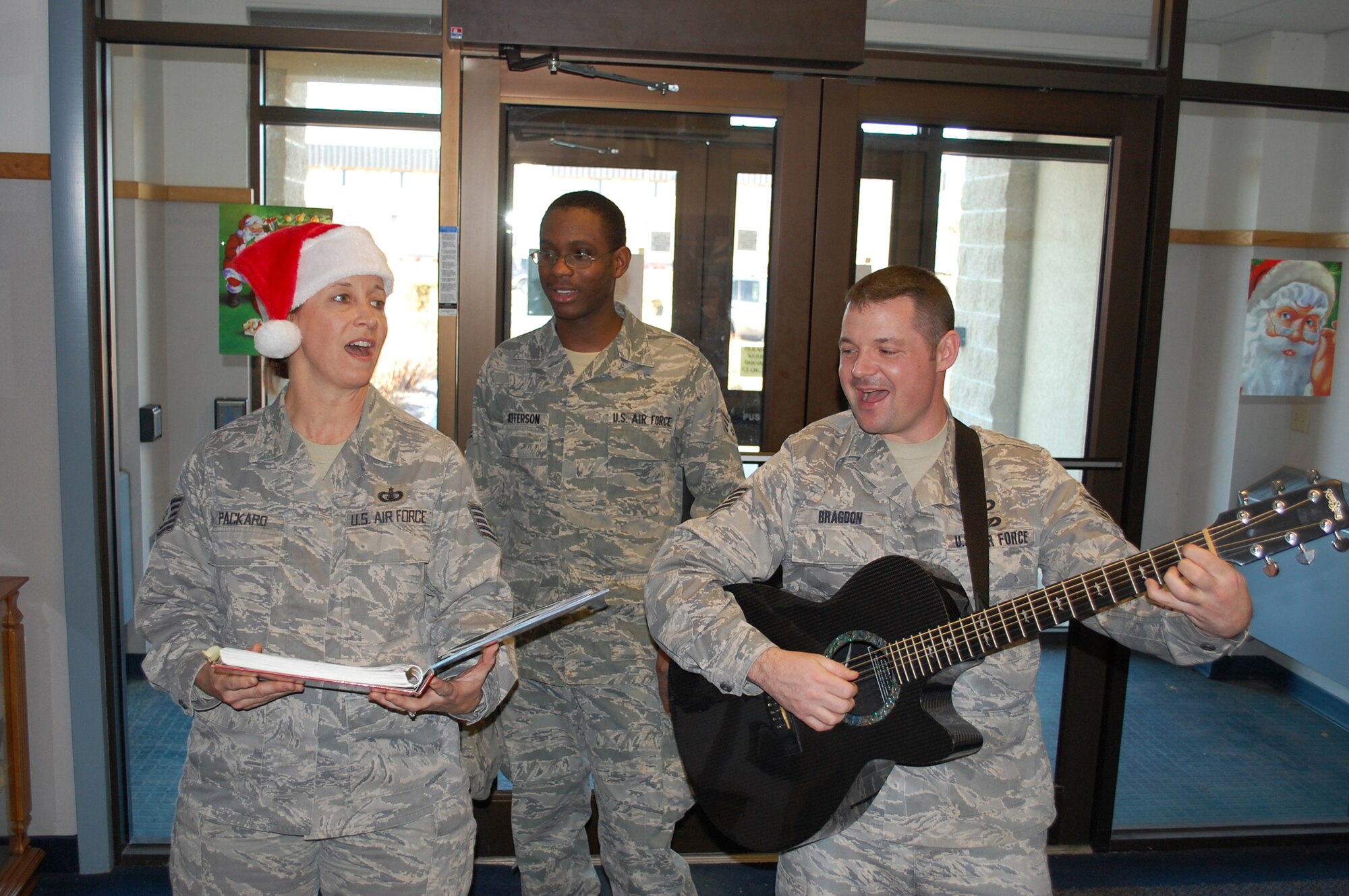 Senior Airman Nathan Jefferson, 341st Force Support Squadron missle chef, sings alongside Tech. Sgt. Rebecca Packard and Staff Sgt. Daniel Bragdon, both U.S. Air Force Heartland of America Band members.