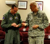LAUGHLIN AIR FORCE BASE, Texas -- Chief Master Sgt. Mike Hanning, former command chief of the 47th Flying Training Wing and the 9th Air and Space Expeditionary Task Force-Iraq and Air Component Coordination Element-Iraq, shows off his presidential challenge coins to Col. Tom Murphy, 47th FTW commander, here Dec. 21.  Hanning served as the senior U.S. Air Force enlisted representative in Iraq. (U.S. Air Force photo/Airman 1st Class Nathan L. Maysonet)