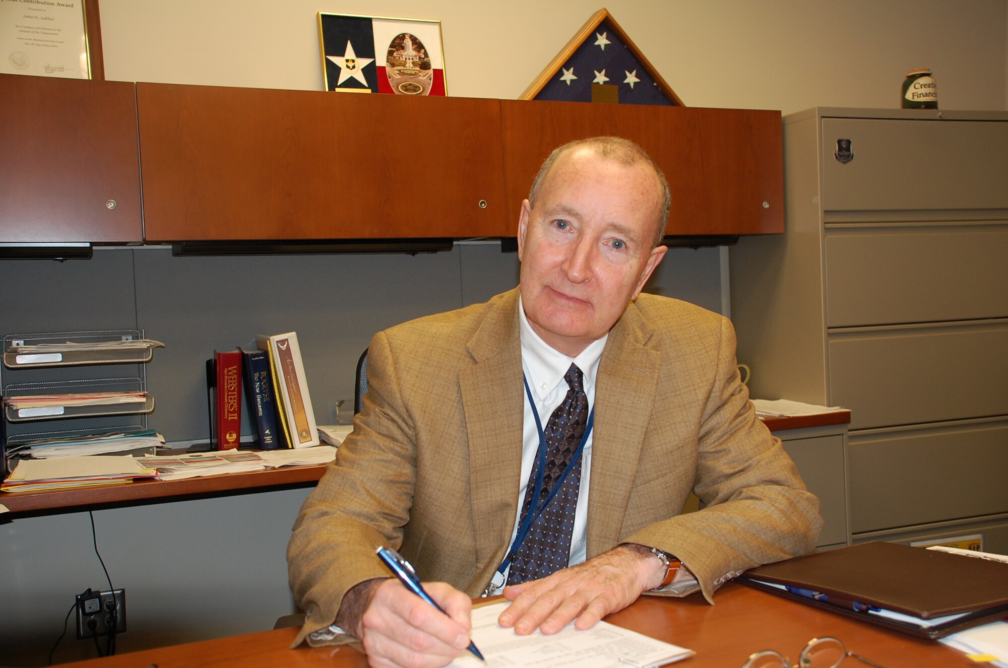 LACKLAND AIR FORCE BASE, Texas -- John LaHue, chief financial officer at the Air Force Center for Engineering and the Environment, was presented a Distinguished Flying Cross during his Dec. 22 retirement ceremony for his service in Vietnam in 1970.