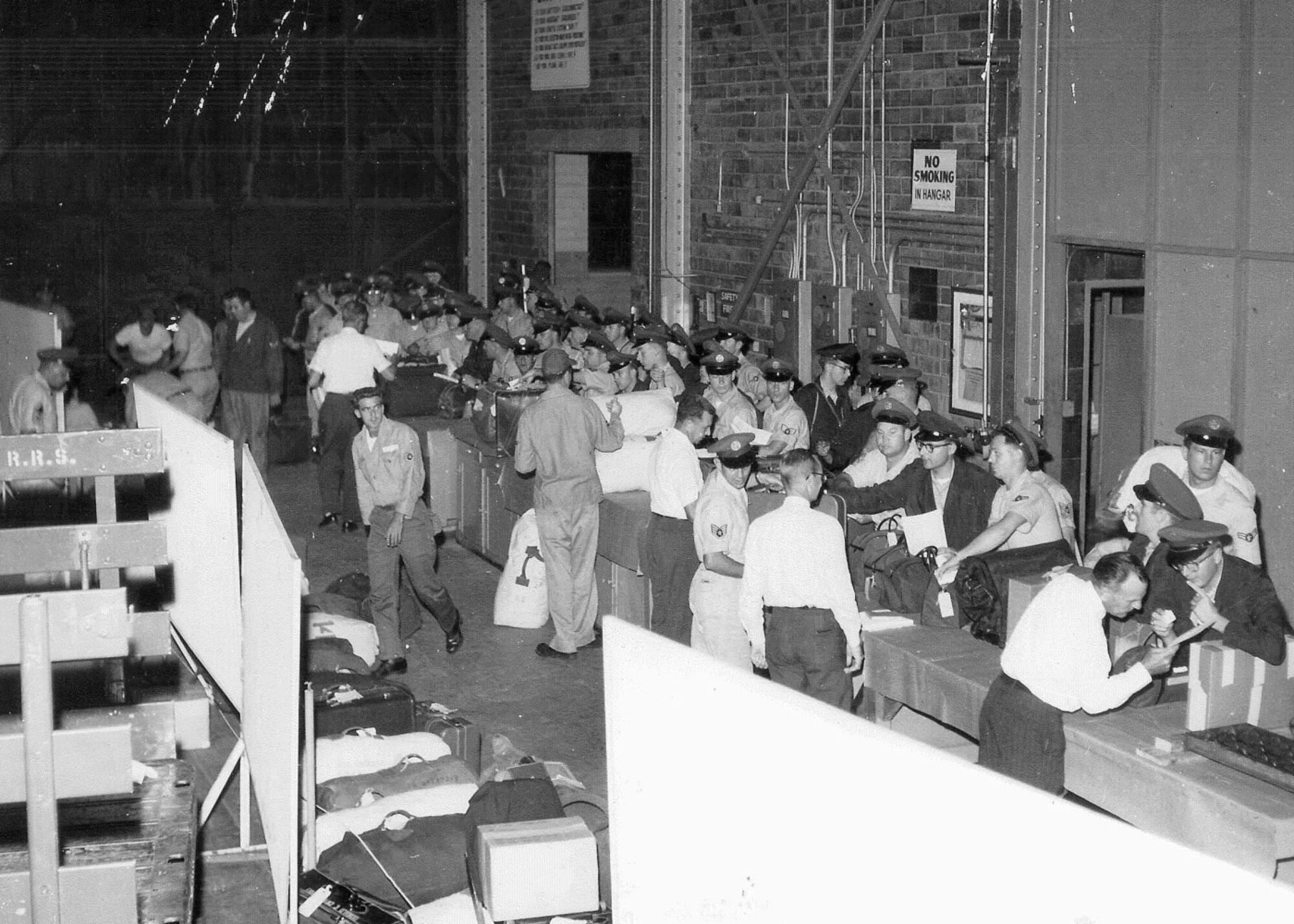 Members of the 131st  Fighter-Bomber Wing, Missouri Air National Guard clear
customs in Hanger 1 at Lambert Air National Guard Base-Saint Louis after their return 
from France in August, 1962.  (Photo by 131st Bomb Wing)
