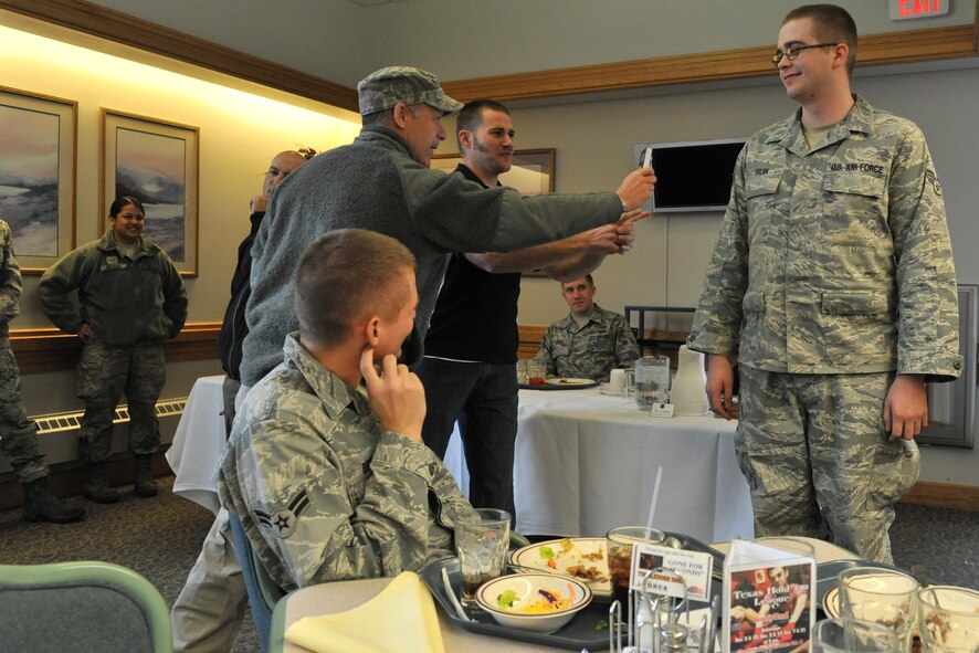 Rob Powers gets things started by pitting Mike Schultz (right) and Chad Crittenden (behind Schultz) against one another in a competition to see who could get the most ranks of selected Airman correctly. This two-week tour is the first exposure to the military for Crittenden and just the second for Schultz. (U.S. Air Force photo/John Turner)