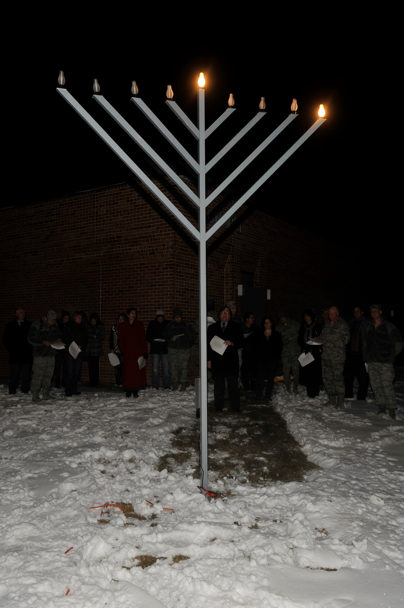 PETERSON AIR FORCE BASE, Colo. -- Rabbi Don Levy, a retired chief master sergeant, presides over the 2011 Menorah lighting ceremony at the Peterson AFB Chapel Dec. 20. The Menorah lighting marks the beginning of Hannukah, an eight-day Jewish holiday commemorating the rededication of the Holy Temple in Jerusalem. (U.S. Air Force photo/Robb Lingley)