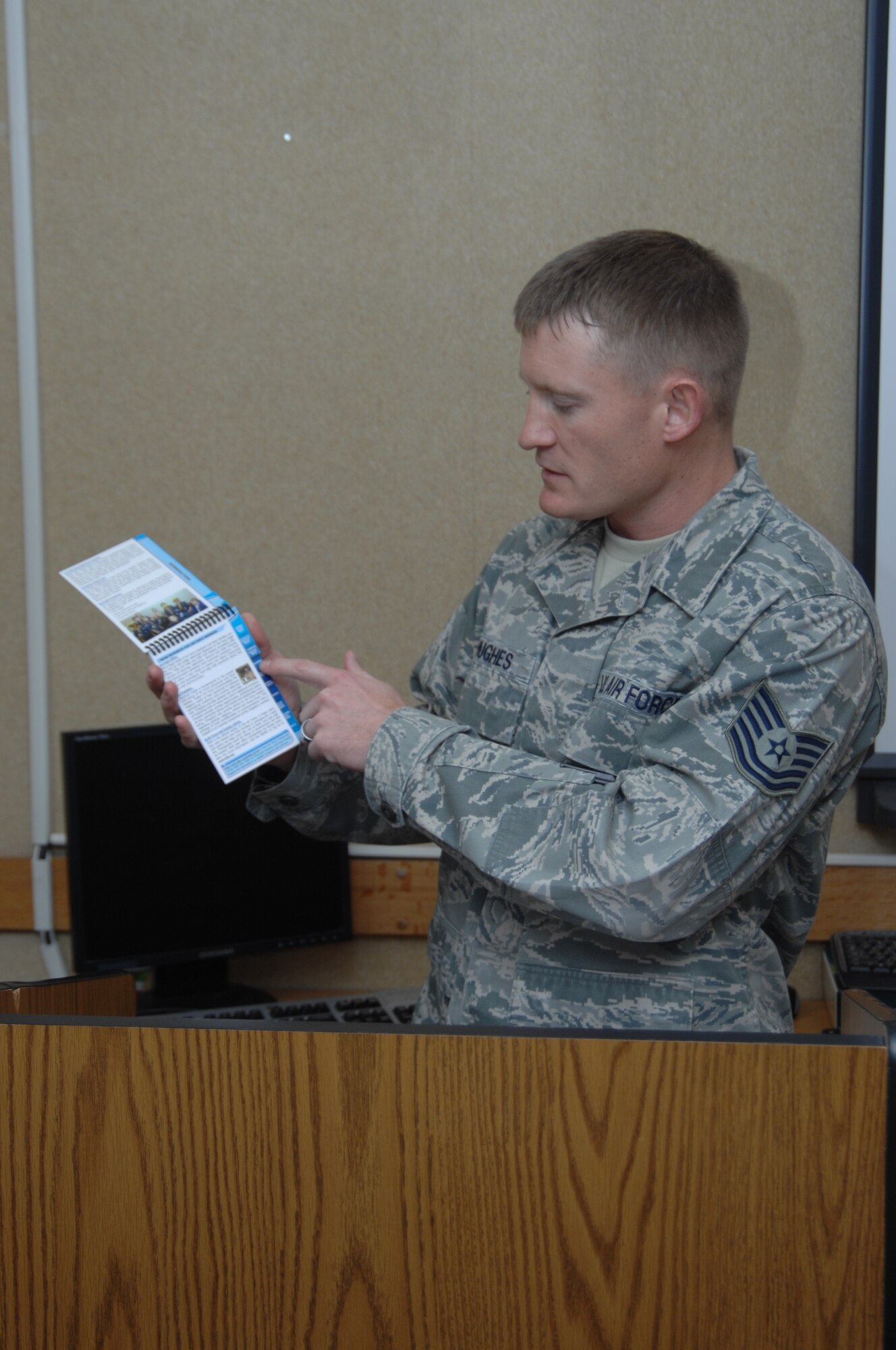 Tech. Sgt. Travis Hughes, 366th Force Support Squadron’s Airmen and Family Readiness Center readiness noncommissioned officer-in-charge, reads through the Air Force readiness and deployment guide Dec. 20, 2011, at Mountain Home Air Force Base, Idaho. The A&FRC offers a wide variety of educational programs, classes and services to military personnel, dependents and retirees. (U.S. Air Force photo by Senior Airman Benjamin Sutton)