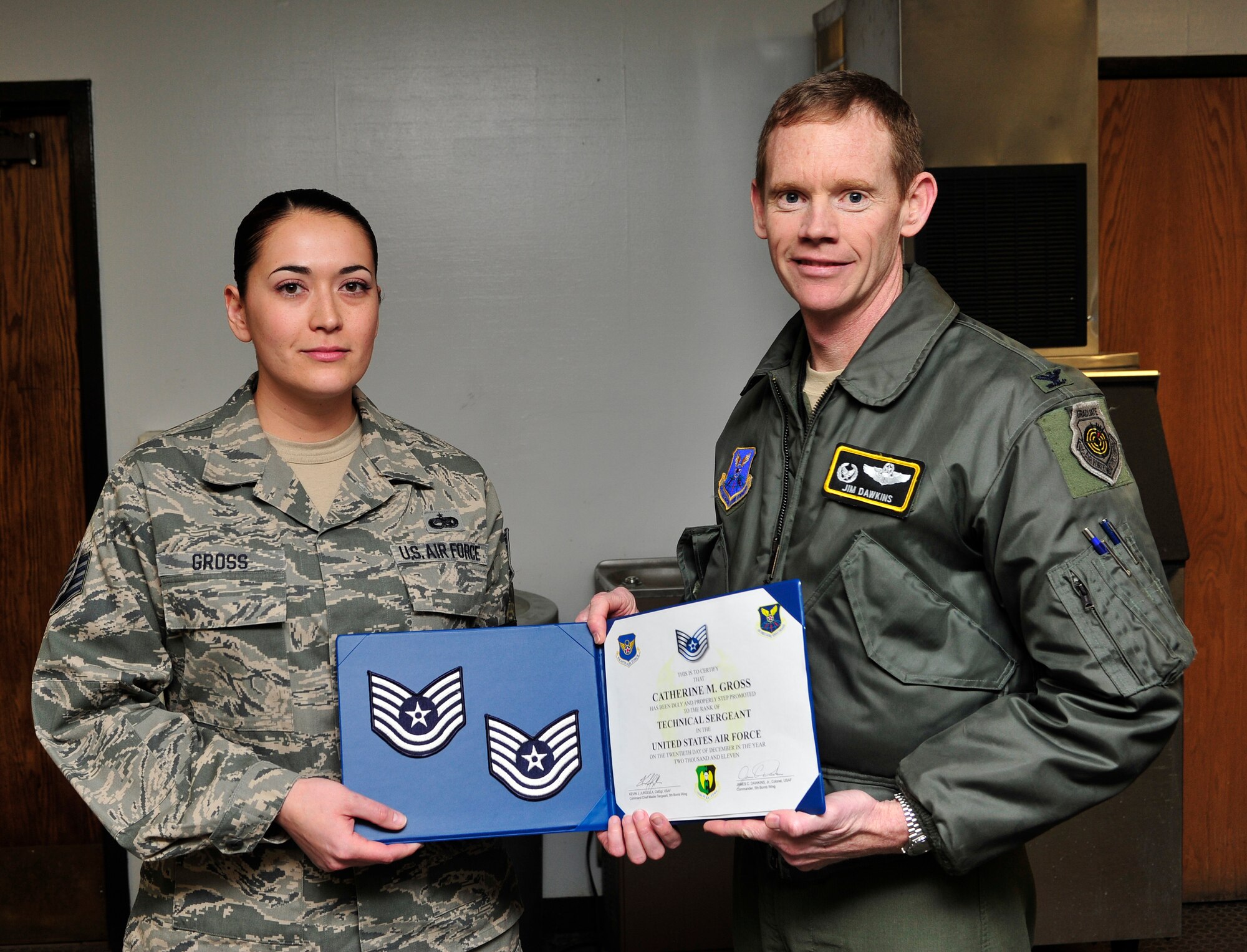 MINOT AIR FORCE BASE, N.D. -- Col. James Dawkins, 5th Bomb Wing commander , step promotes Staff Sgt. Catherine Gross, 5th Aircraft Maintenance Squadron, here Dec. 20. (U.S. Air Force photo/Senior Airman Desiree Esposito)