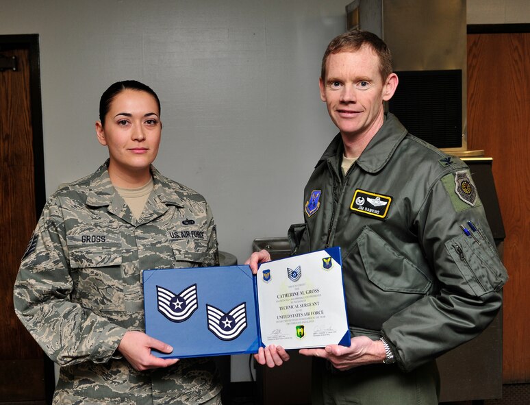 MINOT AIR FORCE BASE, N.D. -- Col. James Dawkins, 5th Bomb Wing commander , step promotes Staff Sgt. Catherine Gross, 5th Aircraft Maintenance Squadron, here Dec. 20. (U.S. Air Force photo/Senior Airman Desiree Esposito)