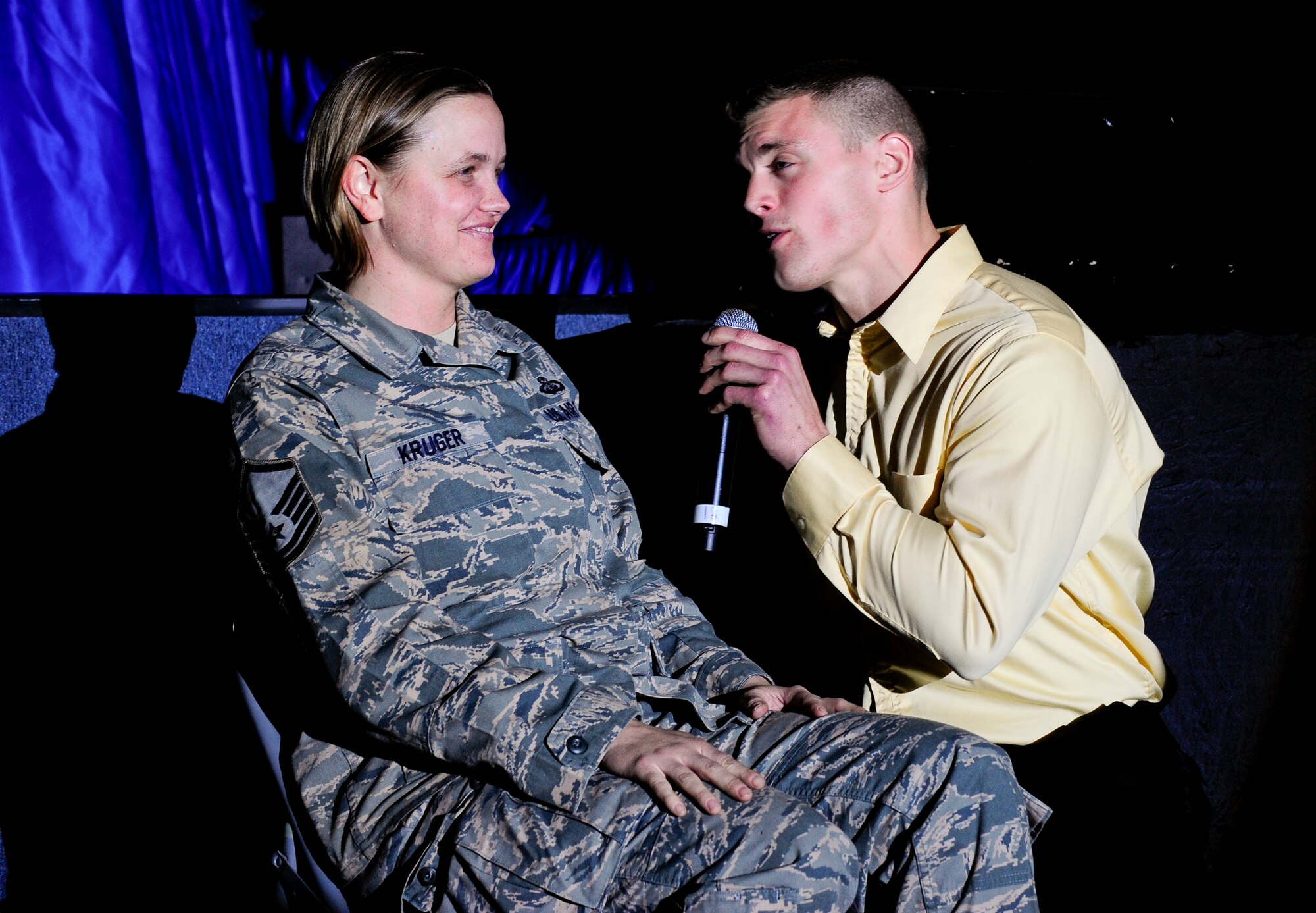 Master Sgt. Kelly Kruger, 376th Expeditionary Force Support Squadron, blushes as 1st Lt. Robert Doyle serenades her Dec. 23, 2011, during the Tops in Blue "Rhythm Nation" world-tour at the Transit Center at Manas, Kyrgyzstan. Kruger is deployed here from Wright-Patterson Air Force Base, Ohio. Doyle is an acquisitions program manager from Vandenberg AFB, Calif. (U.S. Air Force Photo/Staff Sgt. Angela Ruiz)