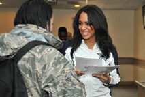 Mia Greenhouse, Dallas Cowboys cheerleader, autographs photos for Airmen at Kunsan Air Base, Republic of Korea, Dec. 21, 2011. The cheerleaders went to the O’Malley Dining Facility, Hangar 3 and the 8th Security Forces Squadron’s weapons simulation to autograph photos and take time to thank Airmen and Soldiers. (U.S. Air Force photo by Senior Airman Brittany Y. Auld/Released))