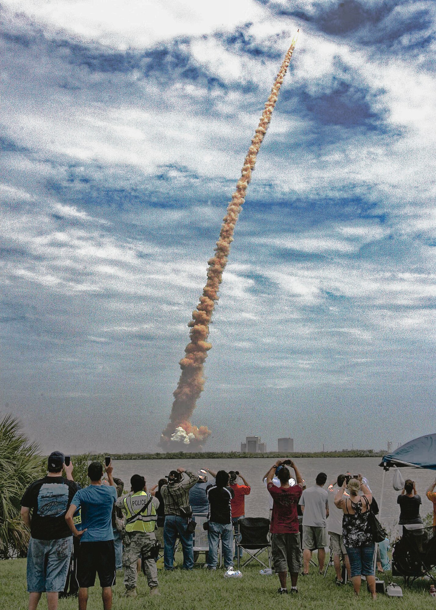 Air Force members and their guests at Cape Canaveral AFS, Fla., watch the final launch of a space shuttle July 8, 2011, from the 45th Space Wing VIP Viewing Area on the NASA Causeway, as Shuttle Atlantis roars into the sky. The success of STS-135 marked the culmination of three decades of support for NASA Space Shuttle missions by the wing, other Air Force units and government agencies, and their mission partners. (Courtesy photo/Ron Trevino)