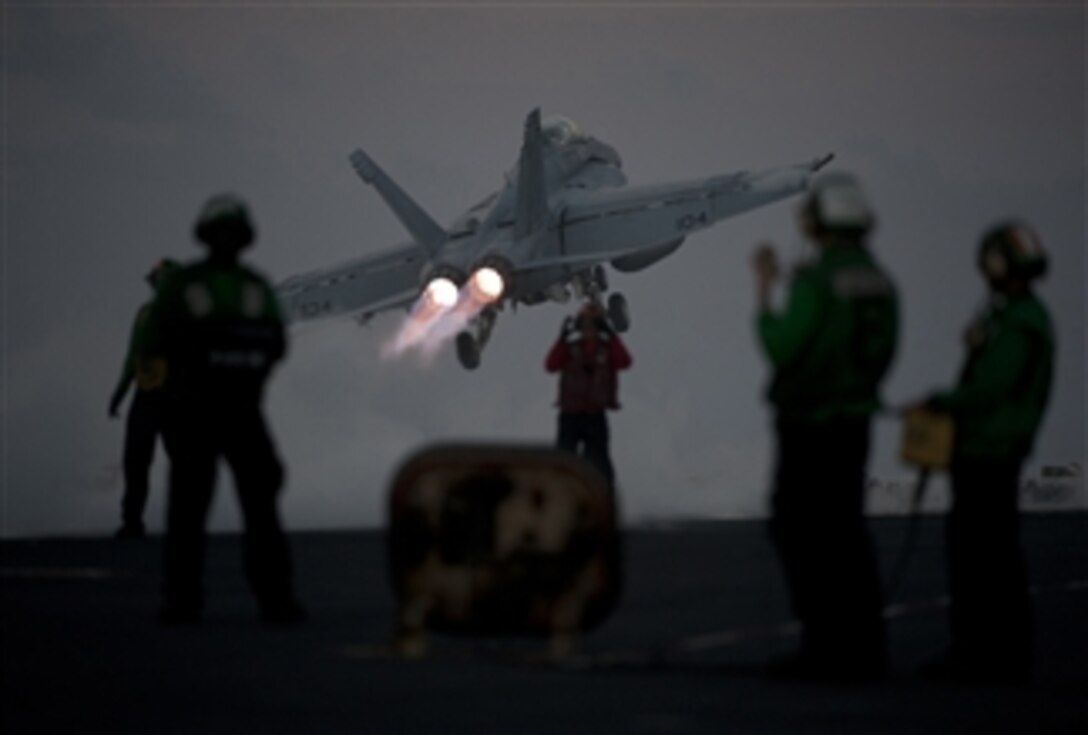 An F/A-18F Super Hornet assigned to Strike Fighter Squadron 22 launches from the flight deck of the aircraft carrier USS Carl Vinson (CVN 70) in the Pacific Ocean on Dec. 21, 2011.  The Carl Vinson and Carrier Air Wing 17 are underway on a western Pacific deployment.  