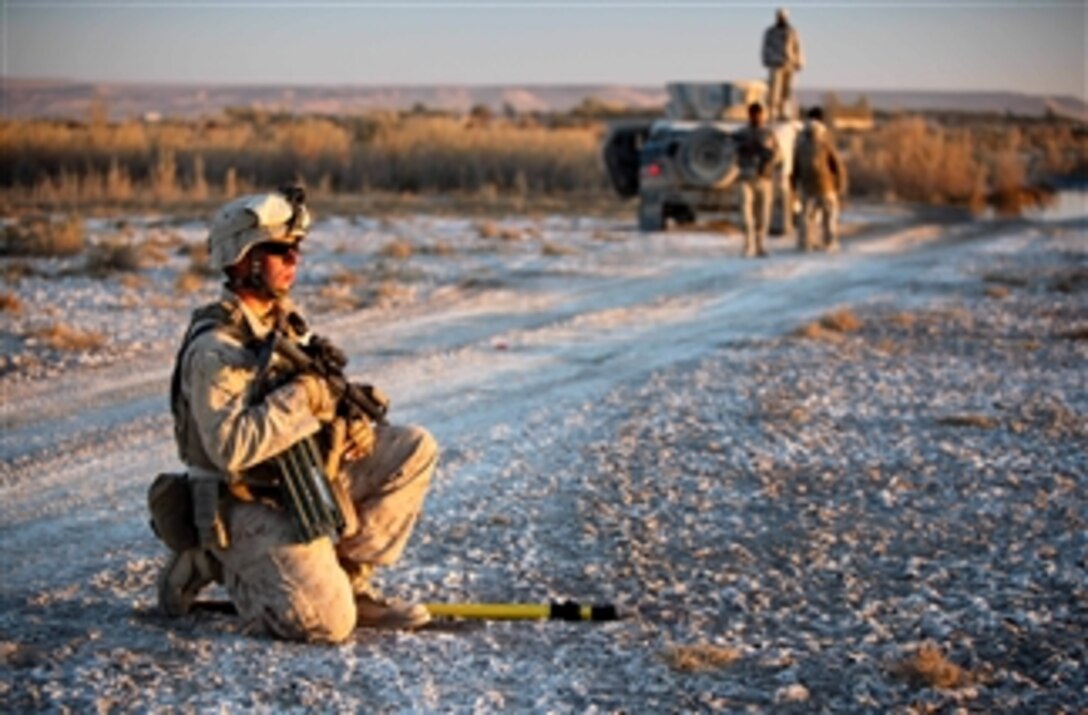 Combat engineer Lance Cpl. Stanton Cromer provides security during an evening patrol with the Afghan Border Police on Dec. 09, 2011.  Cromer is part of Operation Eagle Hunt, an operation led by Afghan security forces to clear the Taghaz area of southern Helmand in preparation for future counterinsurgency operations to expand Afghan-led security.  Cromer and the other combat engineers focused their efforts in leading the many security patrols the Marines went on.  