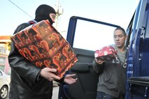 Members of the 8th Security Forces Squadron carry Christmas gifts into the Samsung Orphanage in Gunsan City, Republic of Korea, Dec. 22, 2011. Airmen provided each child with three Christmas gifts. The defenders also served dinner and delivered a little Christmas cheer. (U.S. Air Force photo by Senior Airman Brittany Y. Auld/Released) 