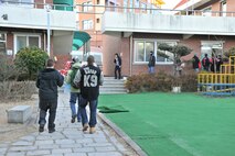 Members of the 8th Security Forces Squadron carry Christmas gifts into the Samsung Orphanage in Gunsan City, Republic of Korea, Dec. 22, 2011. Airmen provided each child with three Christmas gifts. The defenders also served dinner and delivered a little Christmas cheer. (U.S. Air Force photo by Senior Airman Brittany Y. Auld/Released) 