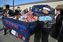 Members of the 8th Security Forces Squadron place Christmas gifts in the back of a vehicle to take to the Samsung Orphanage at Kunsan Air Base, Republic of Korea, Dec. 22, 2011. Airmen provided each child with three Christmas gifts. The defenders also served dinner and delivered a little Christmas cheer. (U.S. Air Force photo by Senior Airman Brittany Y. Auld/Released)