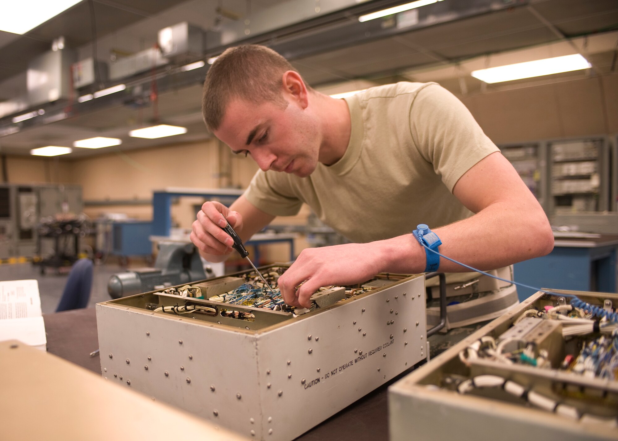 Senior Airman Adam Hefty, 28th Maintenance Squadron avionics test station journeyman, tightens loose wires in a Band 6 Source unit on Ellsworth Air Force Base, S.D., Dec. 28, 2011.  The Band 6 Source units, used on B-1B Lancers, generate defensive electronic warfare signals.  (U.S. Air Force photo by Airman 1st Class Anania Tekurio/released)