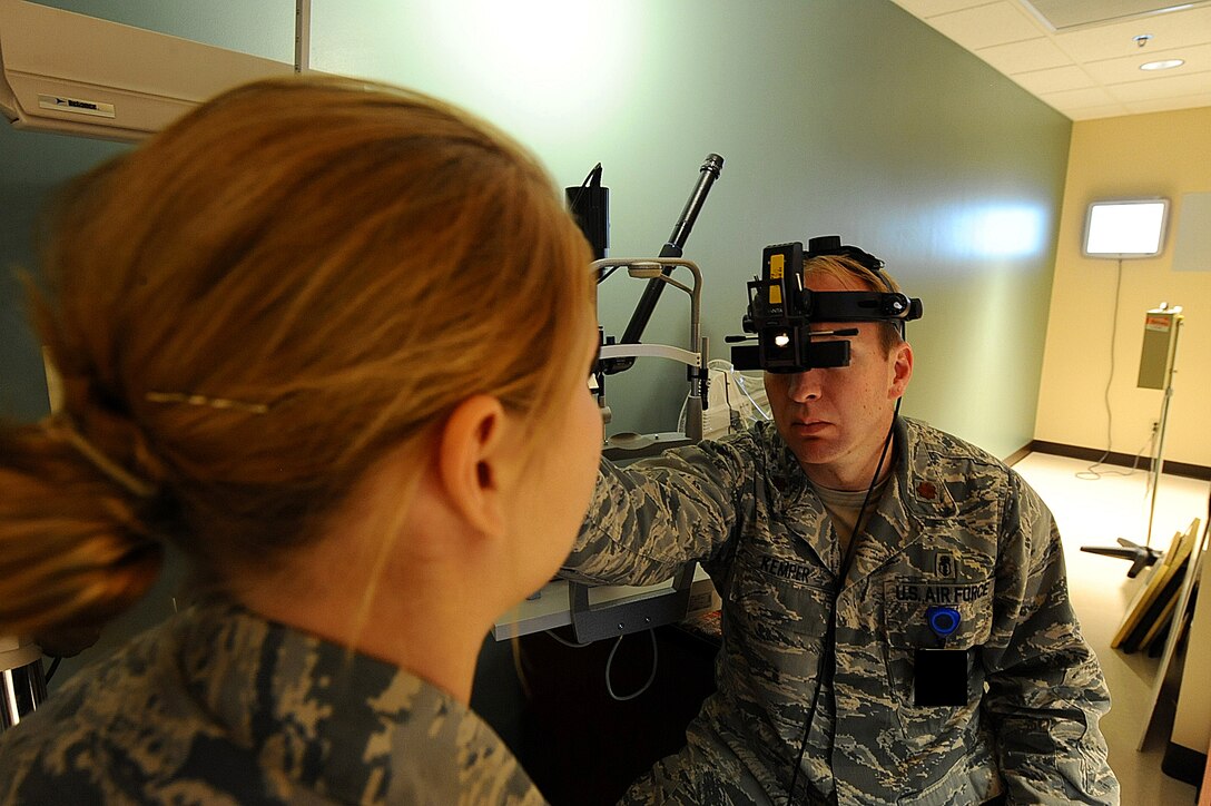 Maj. Bryan Kemper, 28th Medical Operations Squadron chief of optometry, utilizes an indirect ophthalmoscope during a health examination for Airman 1st Class Nichole Porrini, 28th Security Forces Squadron flight member, Ellsworth Air Force Base, S.D., Dec. 13, 2011. Indirect ophthalmoscopes provide a wider view of a patient’s eye to determine the health of the retina. (U.S. Air Force photo by Airman 1st Class Zachary Hada/Released)  