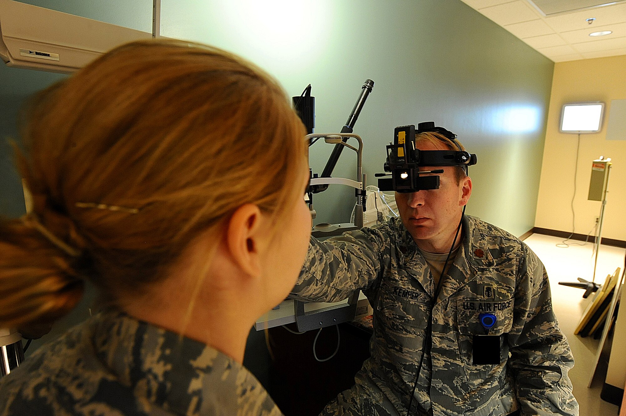 Maj. Bryan Kemper, 28th Medical Operations Squadron chief of optometry, utilizes an indirect ophthalmoscope during a health examination for Airman 1st Class Nichole Porrini, 28th Security Forces Squadron flight member, Ellsworth Air Force Base, S.D., Dec. 13, 2011. Indirect ophthalmoscopes provide a wider view of a patient’s eye to determine the health of the retina. (U.S. Air Force photo by Airman 1st Class Zachary Hada/Released)  