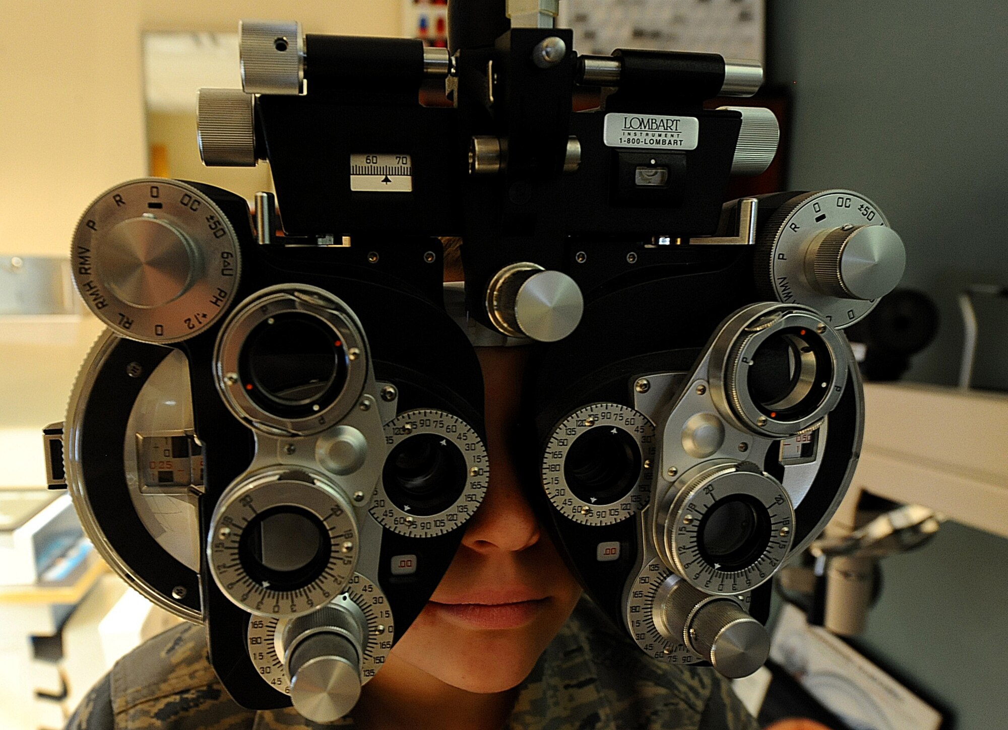 Airman 1st Class Nichole Porrini, 28th Security Forces  Squadron flight member, looks through a phoropter during an examination at the Optometry clinic at Ellsworth Air Force Base, S.D., Dec. 13, 2011. Optometrists use phoropters to measure the refractive status of each eye and determine the correct prescription. (U.S. Air Force photo by Airman 1st Class Zachary Hada/Released)
