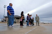 LAUGHLIN AIR FORCE BASE, Texas – Senior Airman Richard Barbado, 47th Civil Engineer Squadron, stands with Angel Pantino, honorary pilot for a day, and his family here Dec. 15. Angel was selected for the Pilot for a Day Program which benefit’s children and their families in local communities who have severe illnesses and have a day completely devoted to them. (U.S. Air Force photo/Senior Airman Scott Saldukas)